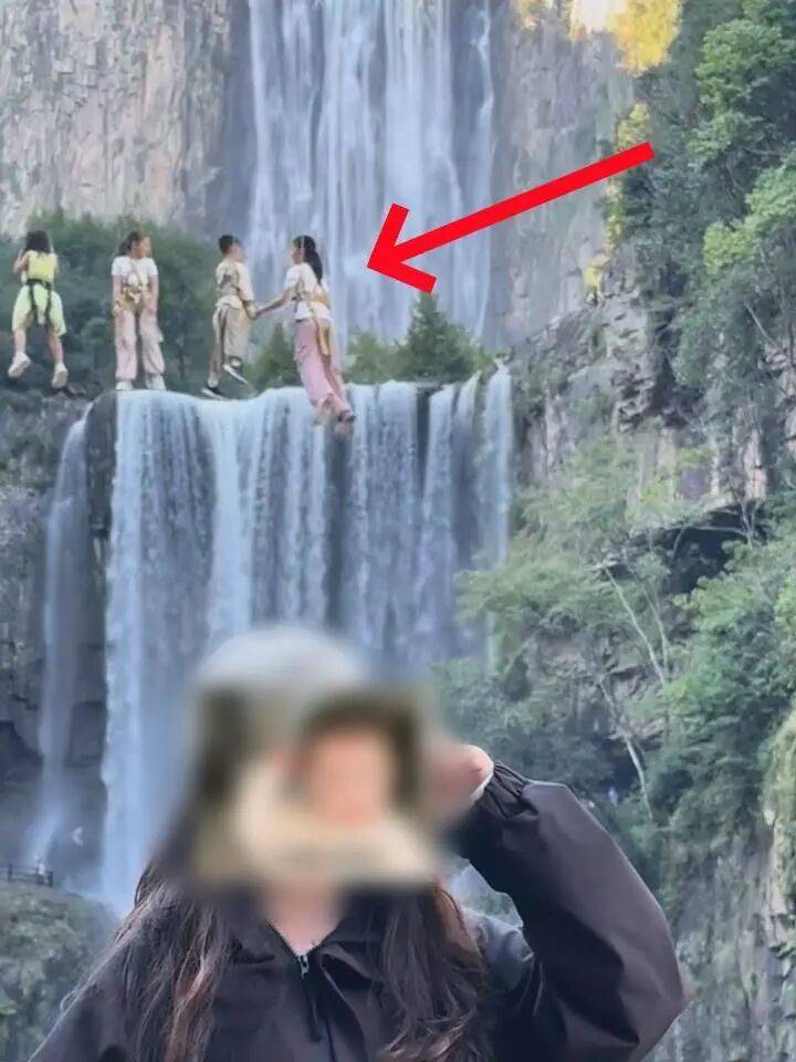 女生瀑布前拍视频，空中突然飘来一排人